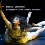 One dancer on their stomach, reaching up with one hand.