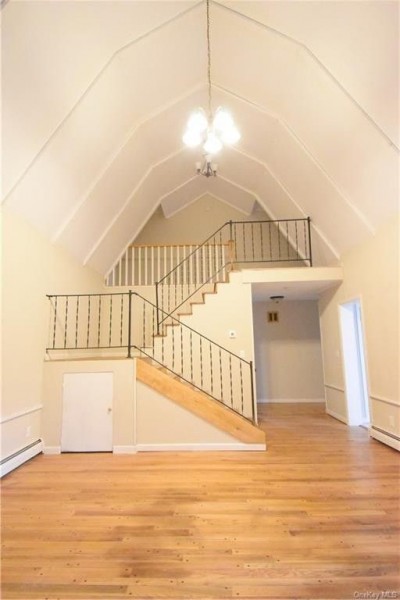 A large, open space with a double staircase in the background.
