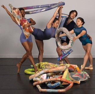 Dancers posing with Meg Lipke sculptures