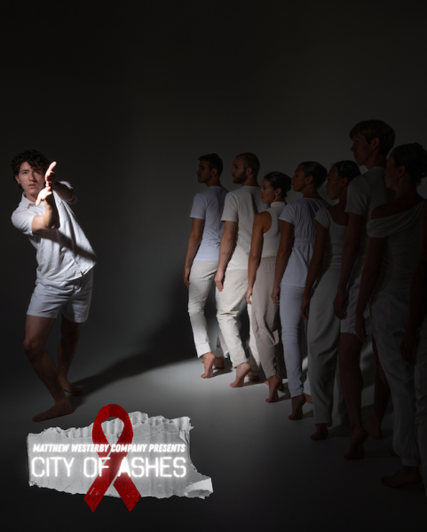 A solo male dancer gestures toward the camera, flanked by a group of dancers to his right. All dancers are dressed in white.