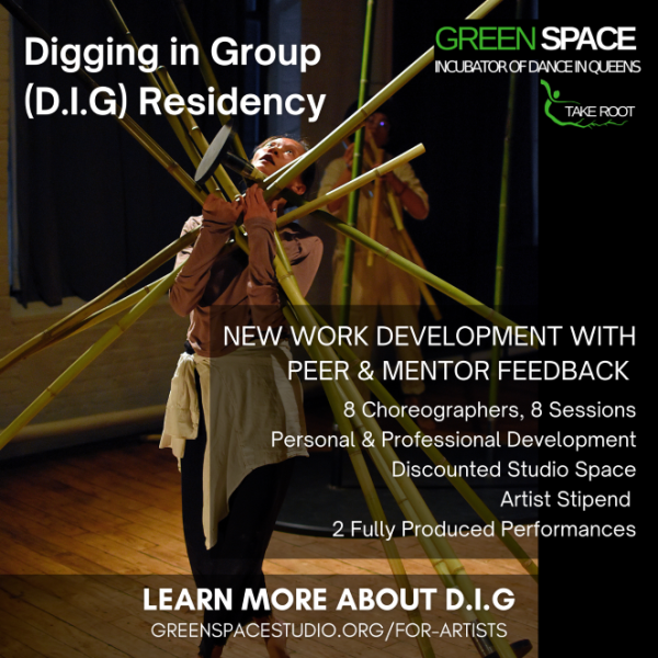 A dancer holding an armful of bamboo