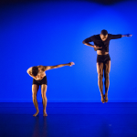 Two male dancers soaring in the air