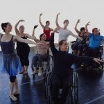 Infinity students, with instructor Kitty Lunn, perform a choreographic phrase together in a dance studio.