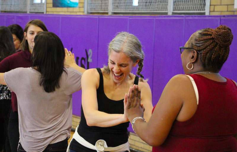 Two women laughing together and dancing at Dancewave's previous FREE Family Salsa Dance class.