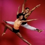 Two dancers captured in a jump