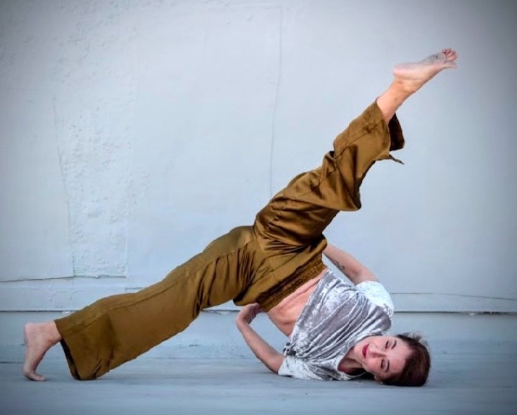 Dancer in a shoulder balance with legs extended in second position