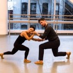 Two dancers in connected shape in dance studio. 