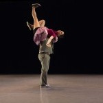 Two swing dancers - the man has lifted the woman onto his shoulder