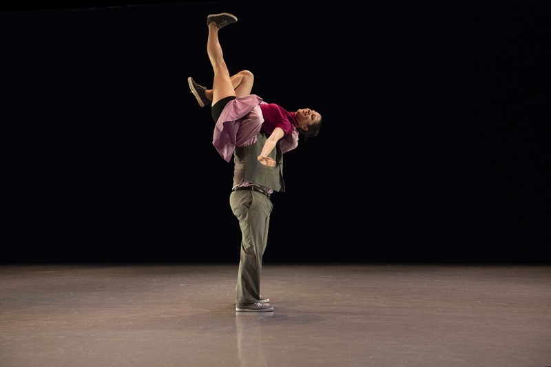 Two swing dancers - the man has lifted the woman onto his shoulder
