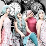 Four performers dressed in pink and green costumes infront of a background of black and white clocks.