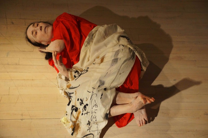 Image of Joan Laage lying on a wood floor