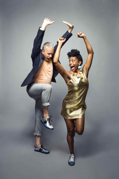 2 people with one leg up, hands in the air and big smiles!