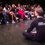 A Community Actionist leads a conversation at an assembly