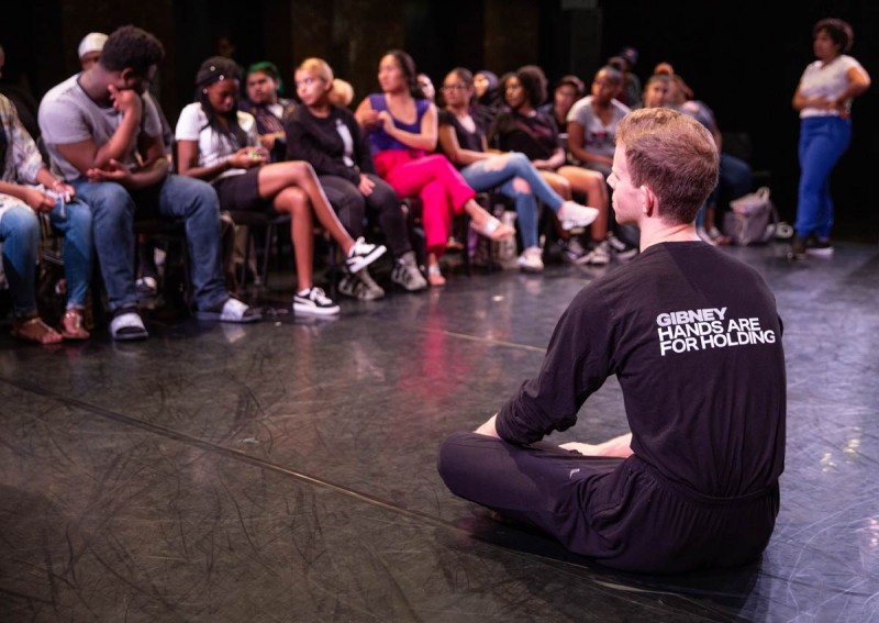 A Community Actionist leads a conversation at an assembly