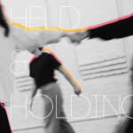 Image of two dancers holding hands with one dancer walking in the back. Text on screen "Held & Holding"
