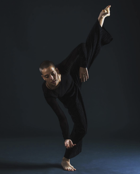 GDC Dancer Leal Zielinska lifts her leg high into the air while eyes focus toward the floor.