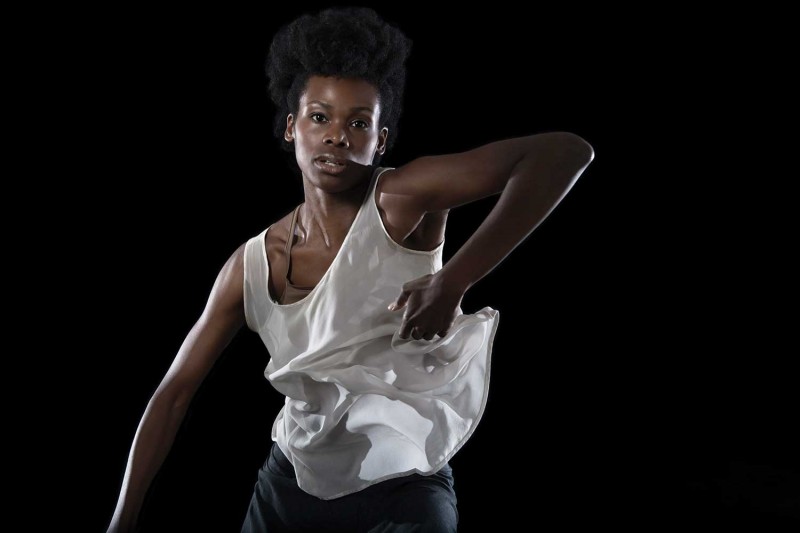 A dancer from Urban Bush Women captured in mid-dance move