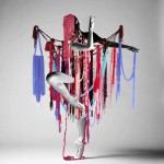 Textile sculpture by Ellie Murphy on ballet dancer arms and legs in red blue purple
