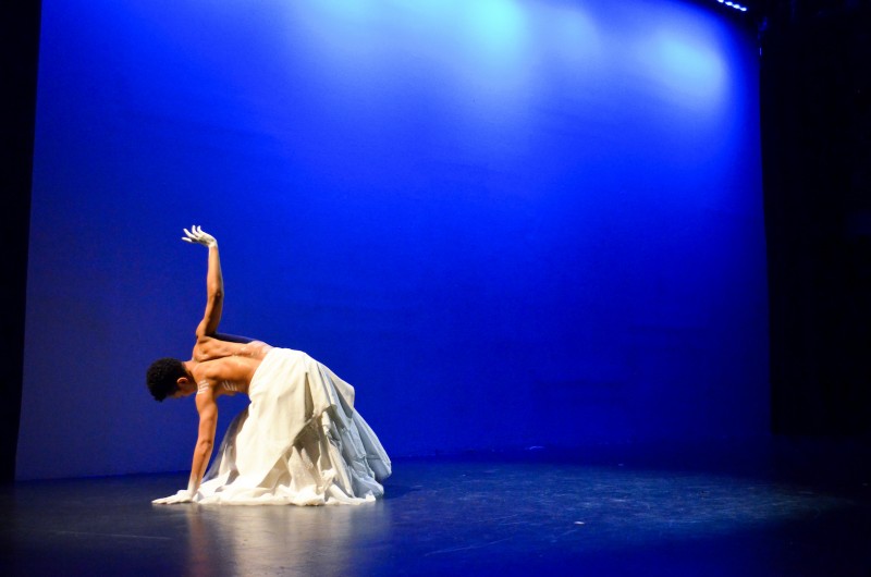 Courtney J. Cook leaning to the left and reaching to the ceiling with her right arm