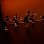 Six women running in slow motion.