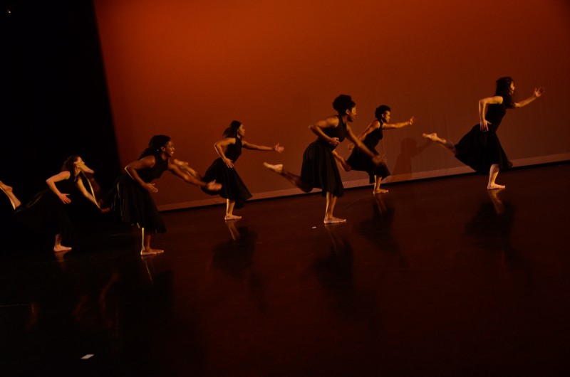 Six women running in slow motion.