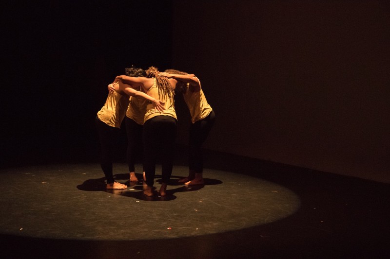 Four women embracing in a circle