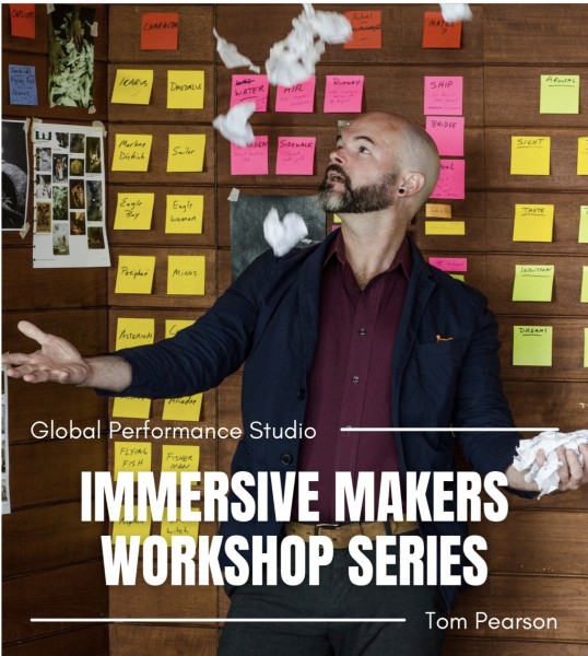Photo of Tom Pearson, with shaved head, beard and dark shirt, juggling crumpled paper, sourrounded by colorful sticky notes.