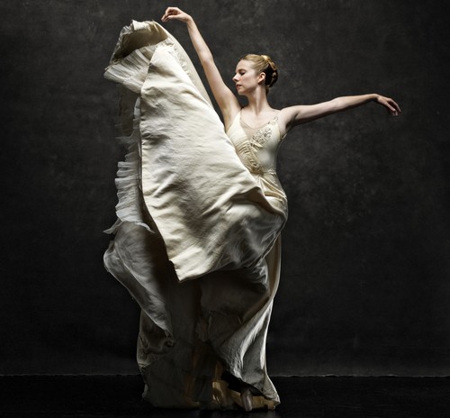 Michelle Wiles, Artistic Director and former principle dancer of ABT, tosses up the bottom of her white dress into the air