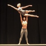 Hanna Q Dance Company, Male Dancers lifting female dancer over his shoulder. Dressed in white.