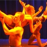 Hanna Q Dance Company, Male Dancers lifting female dancer over his shoulder. Dressed in white. 