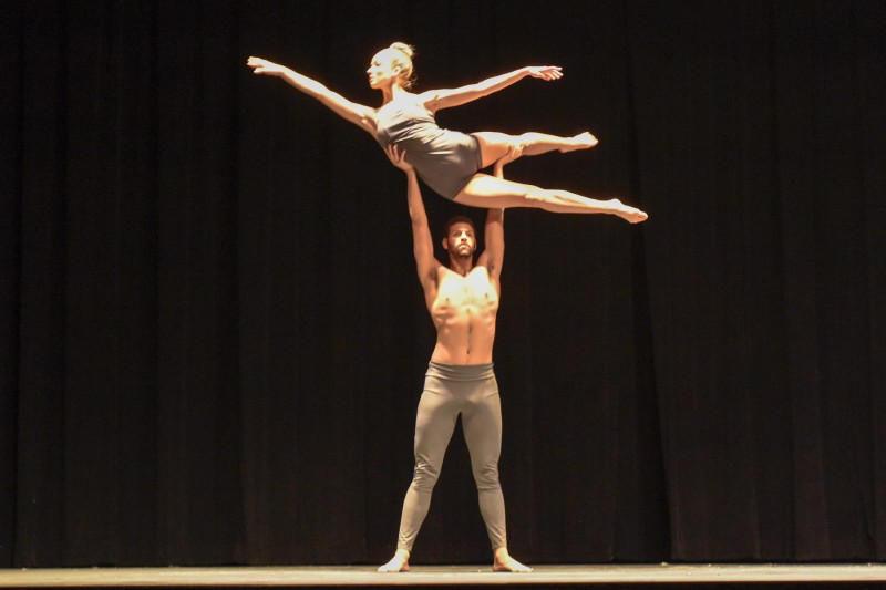 Male dancer lifting female dancer overhead
