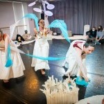 Three dancers with scarves in Flutter with babies watching