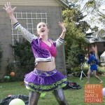 Dancer in sequins with arms over head looking excited
