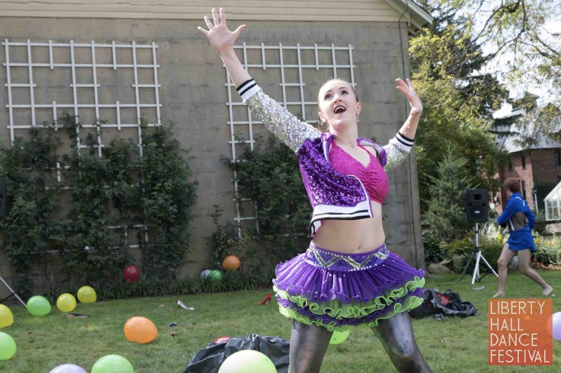 Dancer in sequins with arms over head looking excited