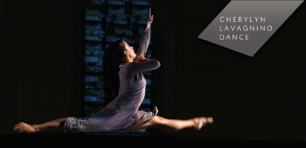 Image of Claire Westby, dancer, in a full split in the air reaching her left arm up