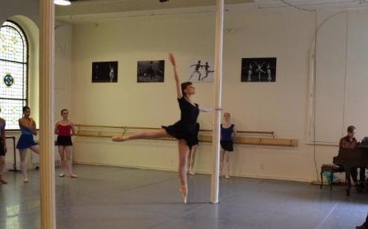 Female dancer jumping in arabesque