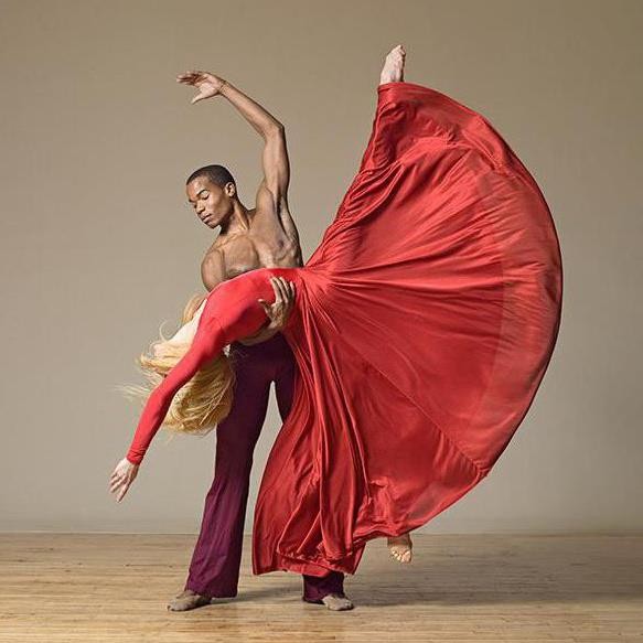 Two dancers partnering together 