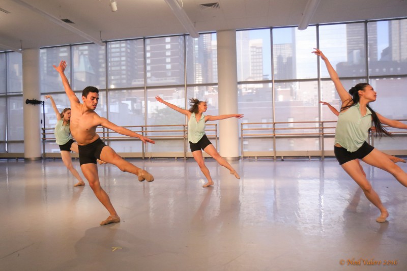 Dancers performing with one leg extended 