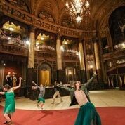 five dancers performing in lobby of theater