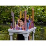 Main character singing Yeats poetry in city sculpture in natural environment.