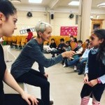 Marie-Christine Giordano and dancer speaking to a student of a public school