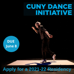 Tap dancer wearing black shirt and pants with white shoes on a wooden platform, stepping out in profile