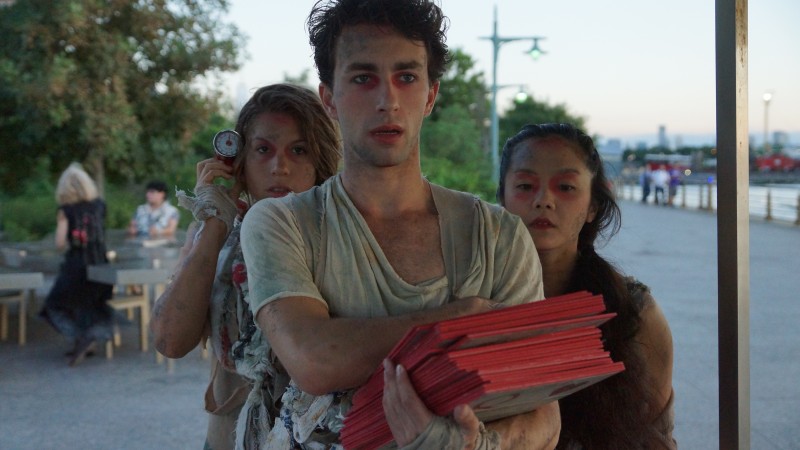 Image from Dress Rehearsal at Hudson River Park. Performers carry the deck of oversized playing cards that contain stories. 