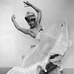 Image of Kathering Dunham dancing with big white skirt and headress
