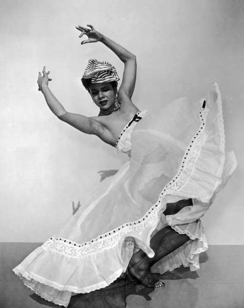 Image of Kathering Dunham dancing with big white skirt and headress