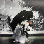 Image of a brown woman dressed in civil war era attire arched while dancing in front of a projection of a B&W vintage photograph
