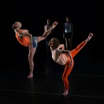 two dancers with their legs gesturing to the backspace while arching their torsos