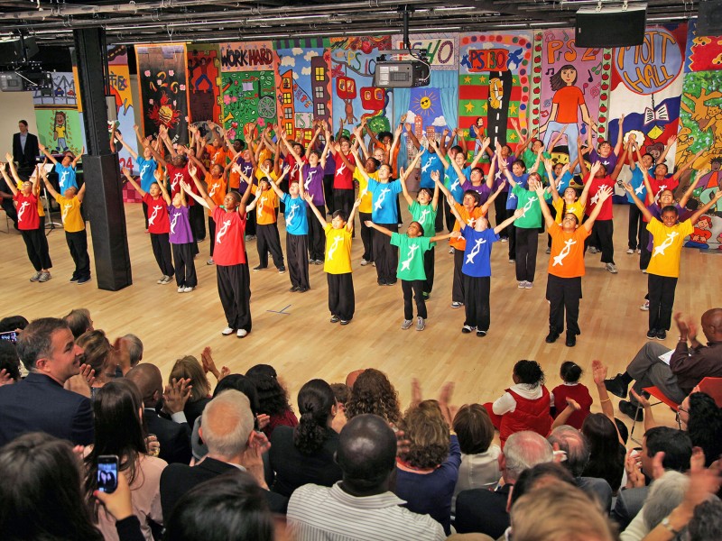 children dancing at the NDI Center wearing colorful NDI shirts