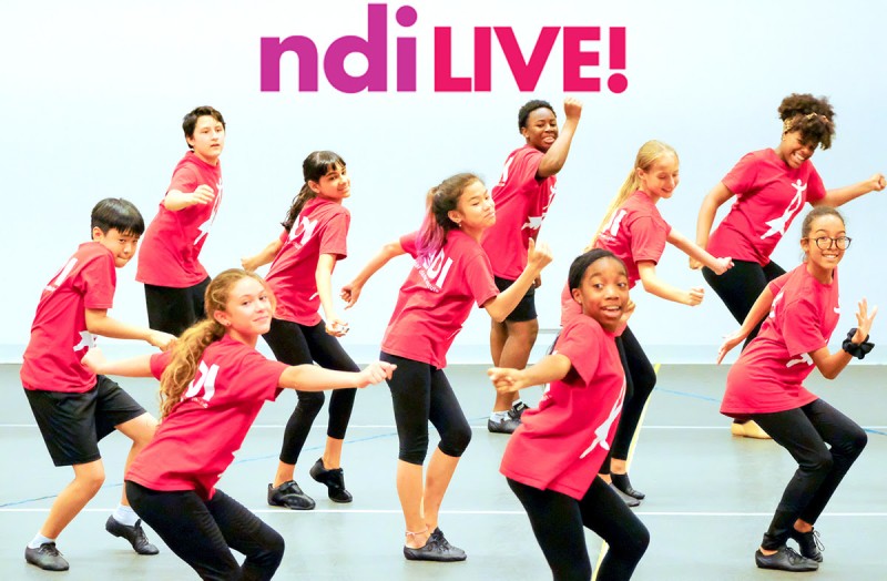 Children dancing in a studio. In bold bright purple letters it says ndiLIVE!
