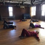 6 people laying on ground with knees up